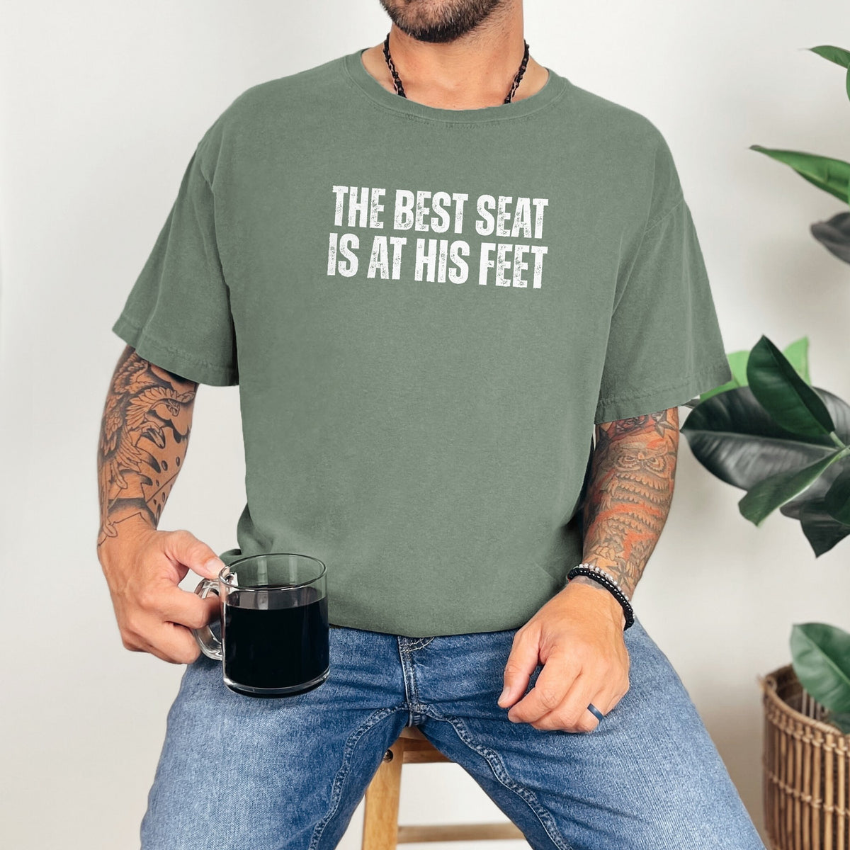 Man wearing The Best Seat Is at His Feet tee in Moss