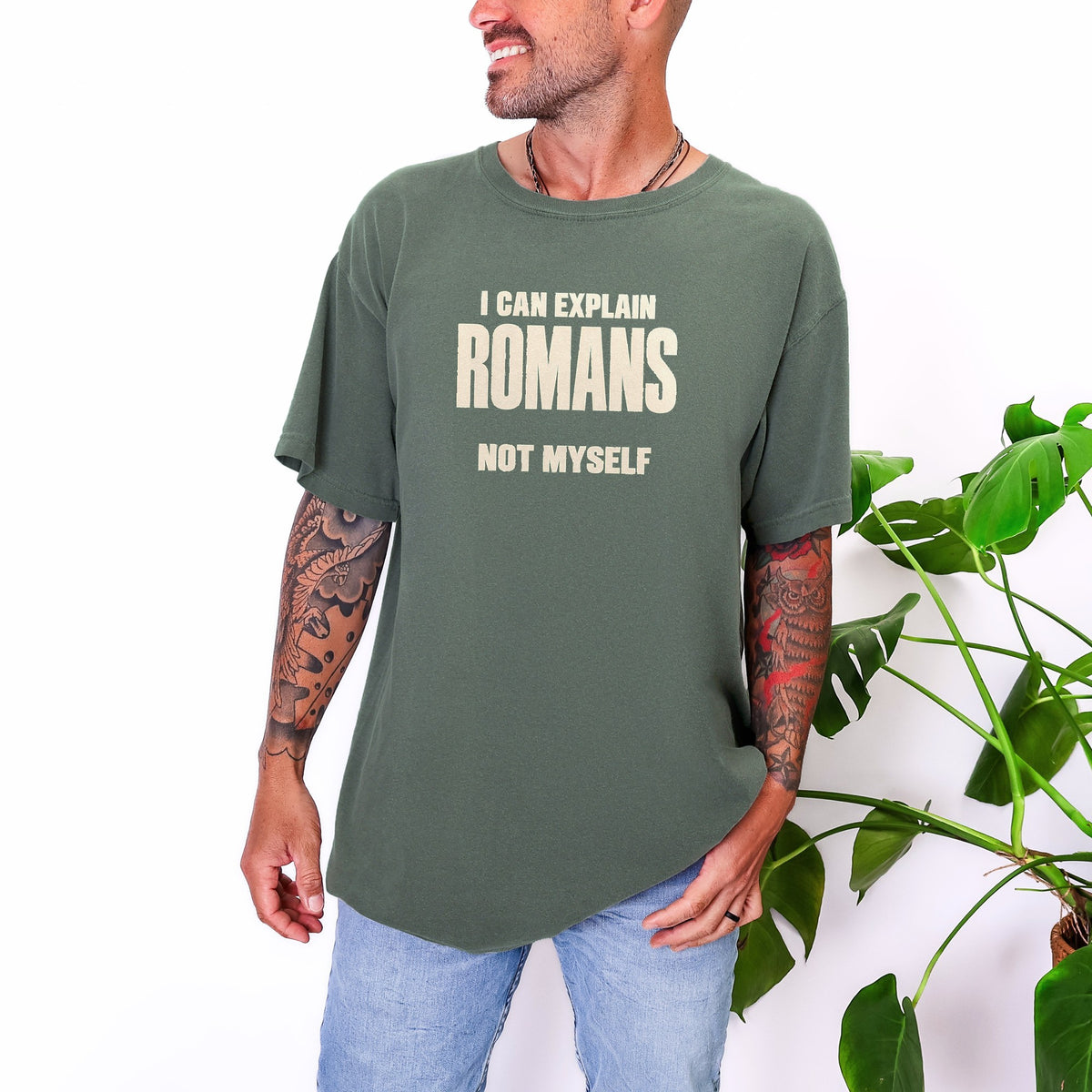 Man wearing I Can Explain Romans, Not Myself tee in Moss