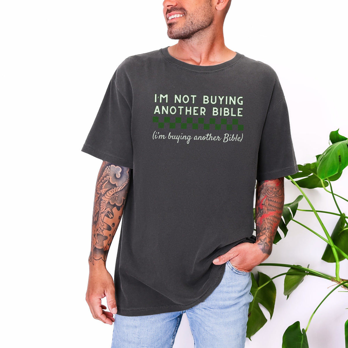 Man wearing I'm Not Buying Another Bible tee in Pepper